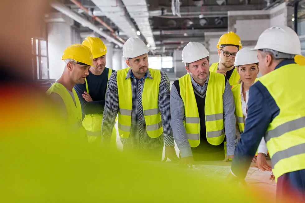 Group of workers huddled together