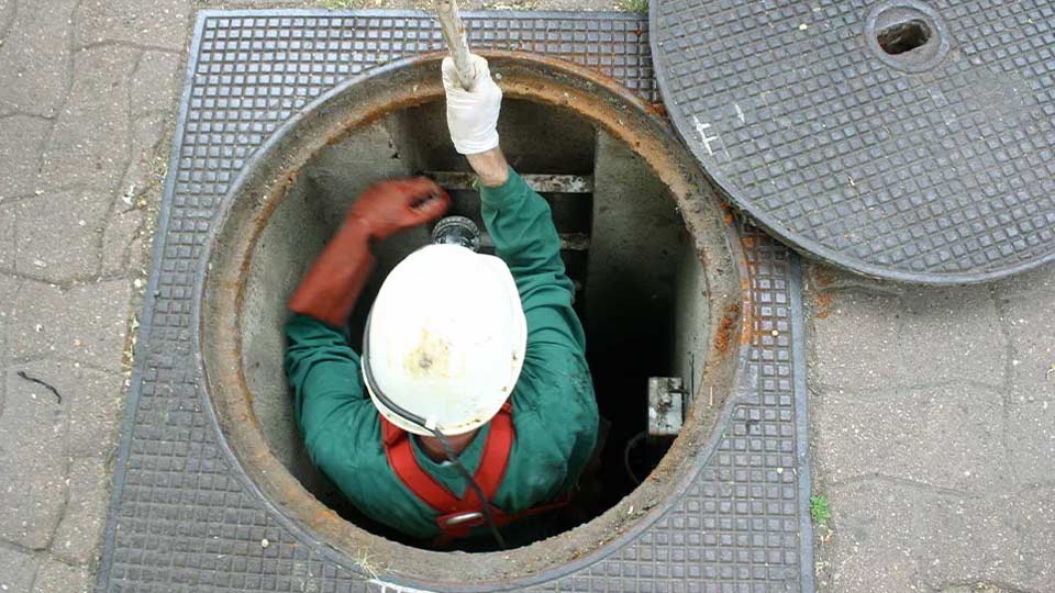Worker in a drainage hole